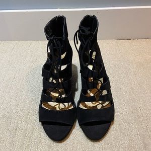 Black suede caged lace up wedge sandals with zipper on the back.